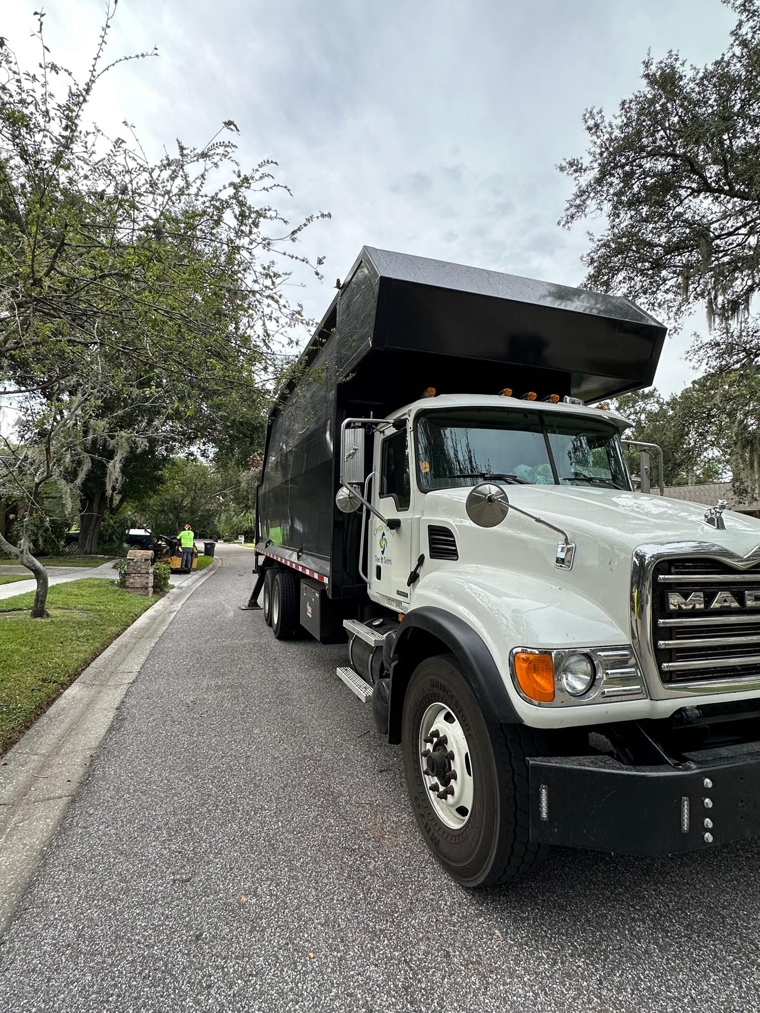 Debris box truck staged for residential cleanup