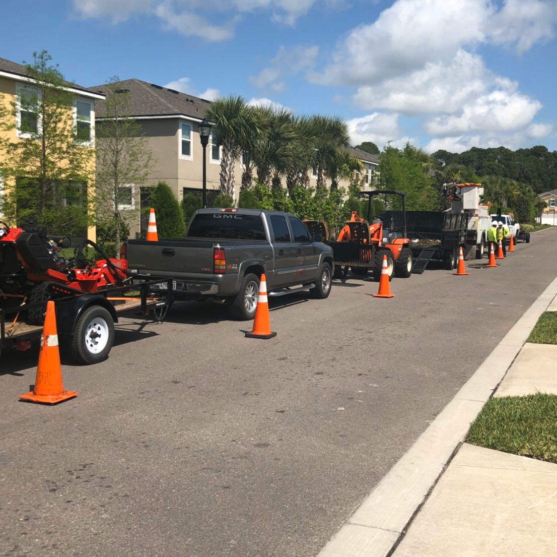 Work convoy and safety cones on residential street