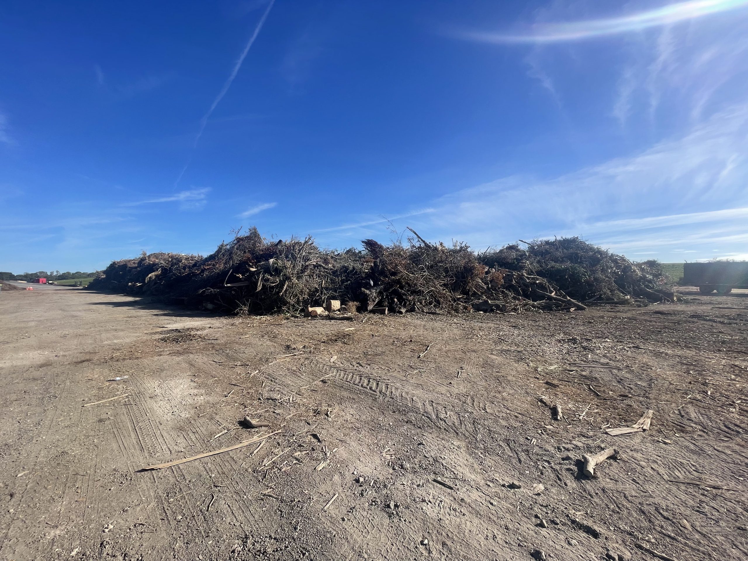 Large debris piles at a staging yard during cleanup